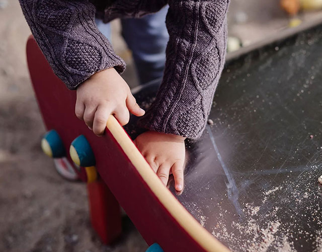 Child wiping a chalk board.